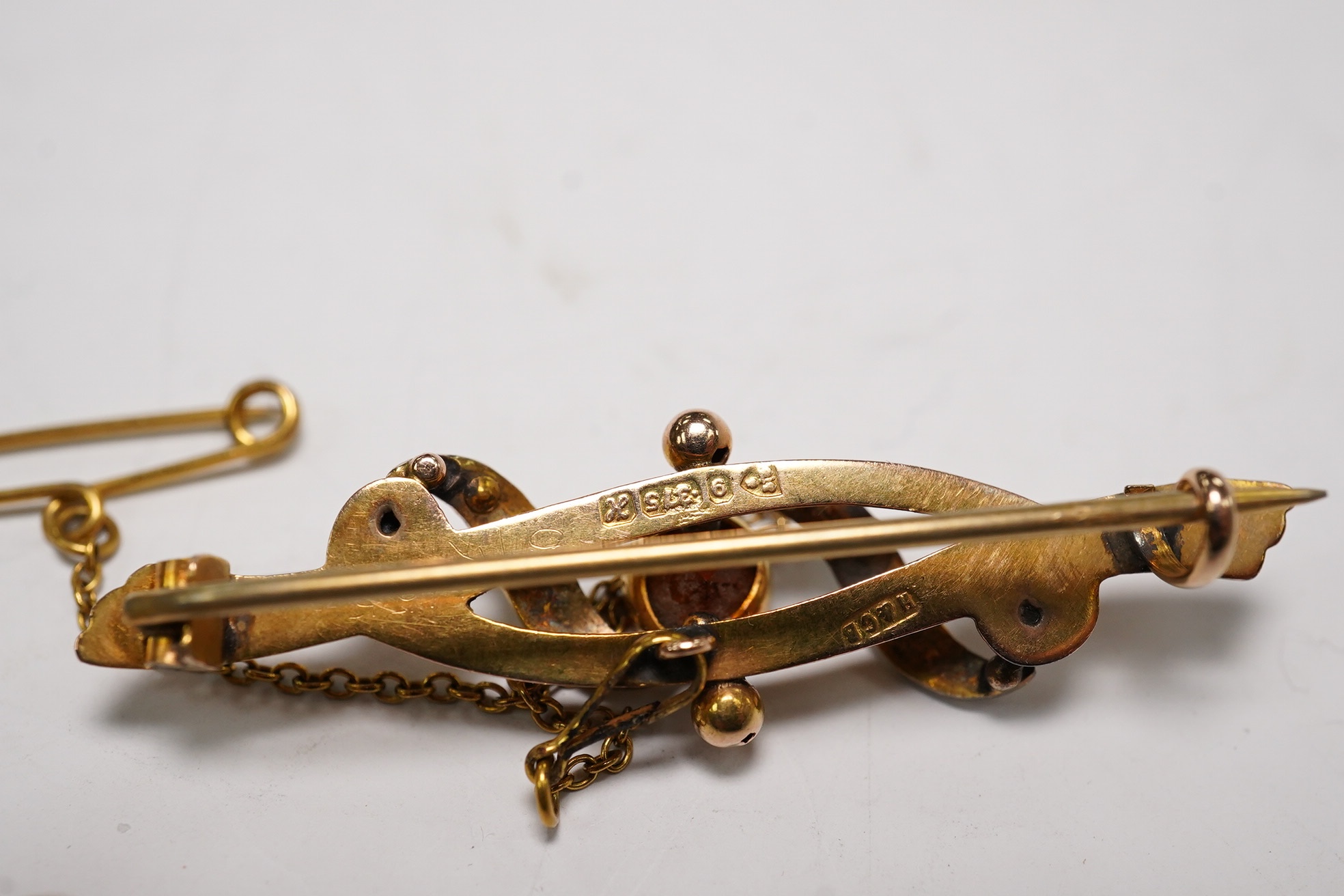 An Edwardian 9ct gold, hessonite garnet and seed pearl cluster set bar brooch, 42mm and a Victorian yellow metal, garnet and seed pearl set bar brooch, gross weight 7.3 grams, Condition - fair to good